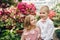 Little boy and girl are walking in a blooming garden