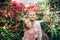 Little boy and girl are walking in a blooming garden