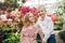 Little boy and girl are walking in a blooming garden