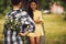 Little boy giving bouqet of flowers to girl.