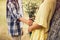 Little boy giving bouqet of flowers to girl.