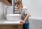 A little boy with glasses in the bathroom brushes his teeth