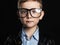 Little boy in glasses.funny child in trendy leather coat