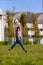 Little boy goalkeeper jumping to catch a football ball.Young african american soccer player training on a grass