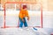 Little boy goalkeeper play ice hockey