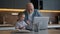 Little boy and grandfather wave greeting gesture with their hands, smile and talk to family through laptop screen