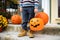 Little boy at halloween party. Child holds a bucket shaped like a halloween pumpkin jack o lantern. Halloween - traditional