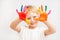 Little boy hands painted in colorful paints