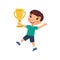 Little boy happily jumps with a golden cup in his hand. Victory concept.