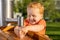 Little boy happily playing with tap water in a sunny playground