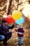 Little boy. Happy childhood. child boy with a bunch of balloons in their hands in yellow autumn park. Family