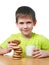 Little boy has breakfast cookies and milk isolated