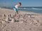 Little boy having on beach fun with the sand. Baby playing on the seaside in summertimes. Summer rest concept. Happy