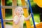 Little boy having fun and eating big lollipop on outdoor playground