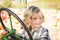 Little Boy Having Fun on A Tractor in a Rustic Ranch Setting at the Pumpkin Patch