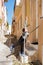 Little boy having fun in traditional streets of Syros Island, Gr