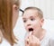 Little boy having his throat examined by health professional