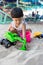 Little boy having lots of fun with his toys playing in the sand outdoors. Concentrated toddler playing with his toy. child plays w