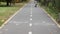 Little boy in a helmet on a bicycle rides on a bike path in the park