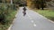 Little boy in a helmet on a bicycle rides on a bike path in the park