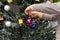 Little boy helping decorate Christmas tree