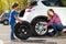 Little boy helping his mother to change flat tyre