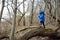 Little boy hiking in the forest on a early spring. Kid playing and having fun in spring or autumn day