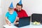 Little boy with his father celebrate birthday online, talking by notebook with relatives and friends