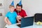 Little boy with his father celebrate birthday online, talking by notebook with relatives and friends