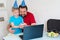 Little boy with his father celebrate birthday online, talking by notebook with relatives and friends