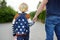 Little boy with his father going to school after summer break. Education for little kids