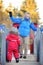 Little boy with his father/grandfather having fun together in snowy winter park