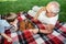 Little boy and his grandfather play chess in the park