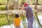 Little Boy and His Grandpa Fishing together