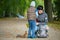 Little boy with his mother feeding a squirrel at a park