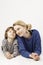 Little boy and his mother lying down close to each other on the white background.