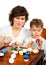 Little boy with his mother paint the Easter eggs