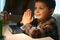 Little boy and his mother praying at home