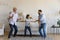 Little boy his older grandfather and father dancing together indoor