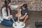 Little boy and his young mother sitting on floor at home assembling a coffee table