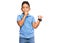 Little boy hispanic kid wearing casual clothes asking to be quiet with finger on lips pointing with hand to the side