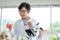 Little boy hold flask contain color chemical and other hand hold dropper during learn to test science experiment with day light.