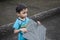 A little boy hold a kite in his hand.