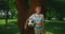 Little boy hold soccerball lean on tree. Young athlete posing with ball closeup.