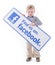 Little boy holding Facebook sign