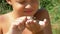 Little Boy Holding a Frog in his Hands and Strokes his Toad by Finger on the Beach near the River