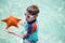 Little boy holding a giant starfish