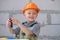 Little boy holding screwdriver. Happy smiling kid twists bolt with screwdriver. Little Repairman with repair tool. Cute