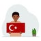 A little boy is holding a Turkish flag in his hands. Concept for demonstration, national holiday, Turkey day or
