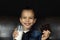 Little boy holds a bar of chocolate and glass of milk in his hands